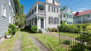 A two-story house with a front porch and a small front yard.