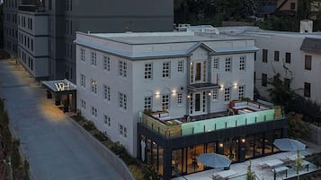 A hotel with a rooftop patio, a ground-level bar, and a classic brick facade.