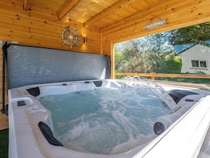 A hot tub with a wooden ceiling and a sign that reads 'Salt Air.'