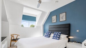 A bedroom with a bed, a nightstand, a chair, a desk, and a window. - 7 Aspire -  a family break that sleeps 4 guests  in 2 bedrooms (York)