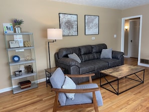 Relax in this stylish living room with a comfortable sofa, armchair, and coffee table.