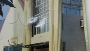 A building with large windows, a prominent entrance, and vertical columns. - Room-ambience Hotel Magodo - Guest Room (Lagos)