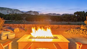 A fire pit with a clear view of a mountainous landscape in the background.