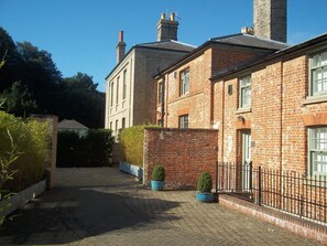 Traditional brick building with a central entrance and symmetrical facade.