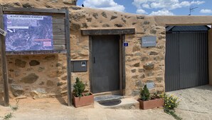 A rustic stone building with a sign indicating 'La Maravilla' and a door marked with the number 2. - THE WONDER Legalized VUT-LE-533 (Tedejo Folgoso de la Ribera. león)