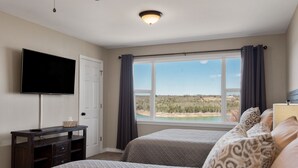 A bedroom with two beds, a TV, a desk, and a window with a view of a landscape. - The View on Bull Shoals Lake! (Lakeview)