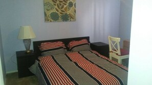 A bedroom with a bed, a nightstand, a lamp, a chair, and a wall decoration. - Big House for Share Near 401-east And Pickering Town Centre (Pickering)