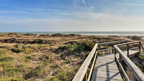 A wooden boardwalk leading to a beach with dunes and a clear sky. - 'The Tipsy Flamingo' ~ Incredible Salt Marsh Views (Atlantic Beach)