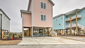 A multi-story residential building with a covered porch and a staircase leading to an upper level. - 'The Tipsy Flamingo' ~ Incredible Salt Marsh Views (Atlantic Beach)