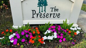 A sign with the text "The Preserve" and a tree silhouette.