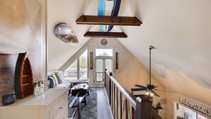 A cozy loft bedroom with a loft bed, a wooden ceiling, a view of the outside, and a sign reading "Lake House". - Spacious and Tranquil Lazy Lake Lodge Escape (Lake Ariel)