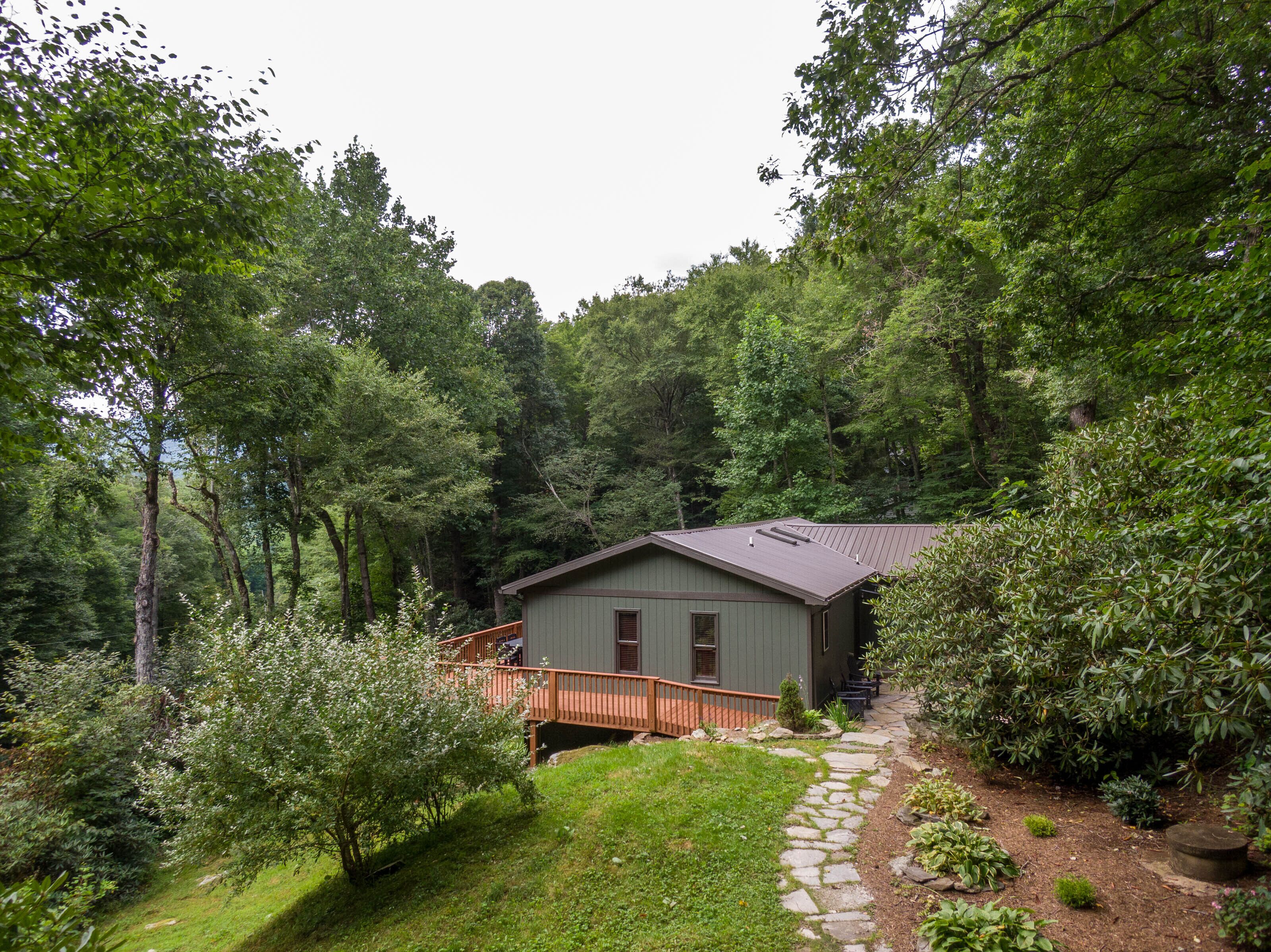 Tucked into the trees and all yours. Snaggys Retreat sits in a lush Blue Ridge forest with a wood deck and winding stone path to the door.