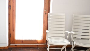 A wooden door with a white chair on the right. - M283 - Marcelli, two-room apartment 200mt from the sea (Marcelli)