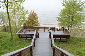 A wooden boardwalk leading to a beach with benches and railings. - 🏖️Sleepy Hollow Beach Resort, Cottage 3C – Family Fun on Lake Michigan! (South Haven)