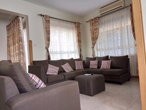 Villa | Living room | 30-inch TV with digital channels - Captivating 3-bed Villa (Entebbe)