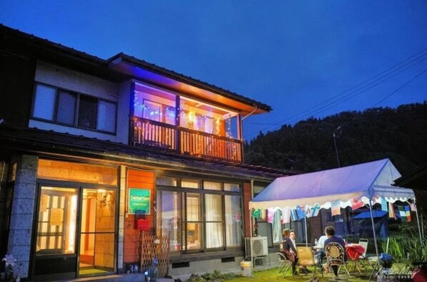 Enjoy a meal on the balcony overlooking the lawn and hill.