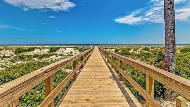 A wooden boardwalk leading to the beach with a clear view of the ocean and dunes. - Amelia Island oceanfront home on Sandpiper Loop, amazing views & steps to ocean (Fernandina Beach)