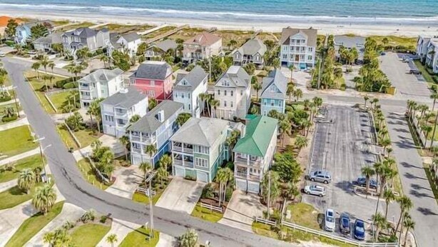 A coastal residential area with houses, a parking lot, and a road. - Seaport Village 1457 - Second Row in Garden City Beach (Garden City Beach)