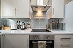 Luxury Apartment | Private kitchen | Full-size fridge, microwave, oven, stovetop