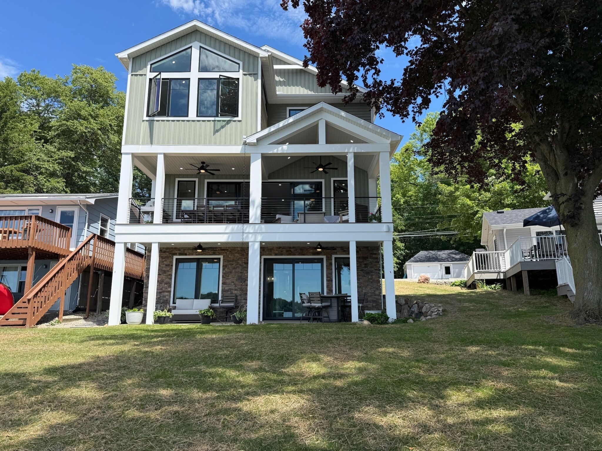 Three-story lake home with multiple deck levels