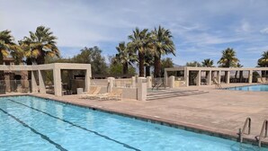 A rectangular pool with clear blue water, surrounded by lounge chairs and palm trees. - Casa de Vistas~ 2bdr 2bath with a view! (Borrego Springs)