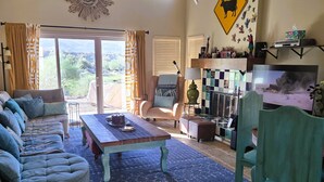A cozy living room with a sofa set, a coffee table, and a fireplace. - Casa de Vistas~ 2bdr 2bath with a view! (Borrego Springs)