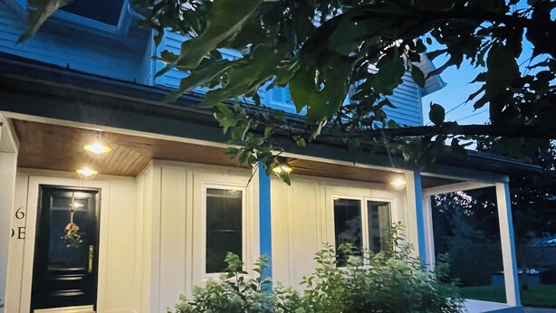 A house with a porch, a door, and windows.