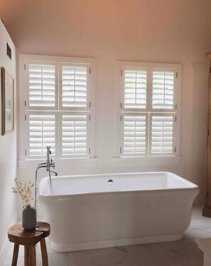 Bathtub, hair dryer, towels, soap