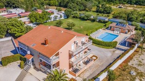 A multi-story building with a swimming pool, surrounded by greenery and other residential buildings. - Apartment Rok 2 by Interhome (Pula/Banjole)