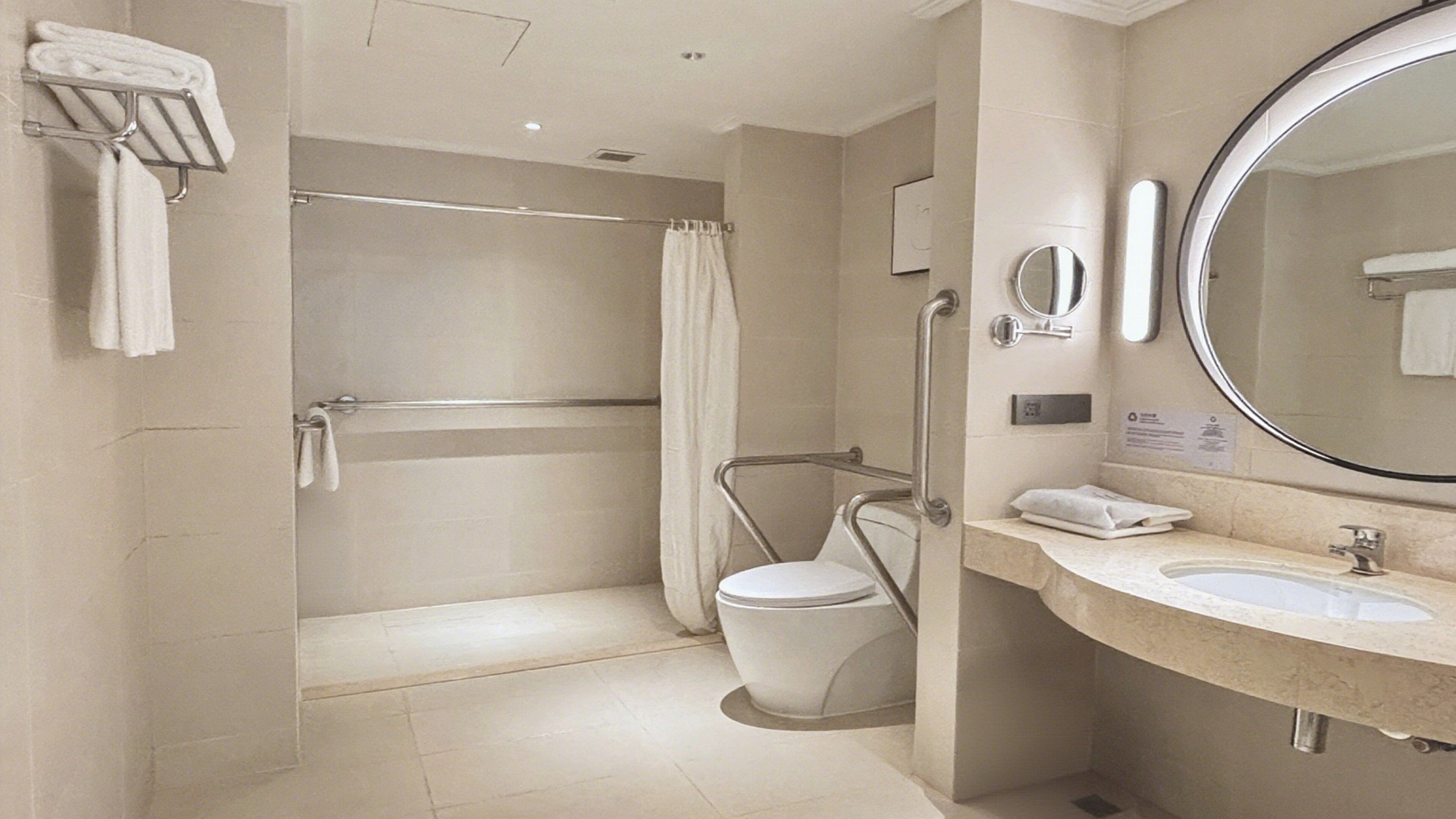 A modern bathroom with a walk-in shower, a toilet, and a sink with a mirror.