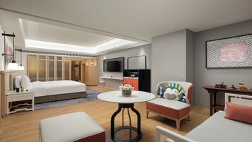 Una habitación de hotel moderna con una cama, una mesa redonda con un jarrón de flores, un televisor y un armario.