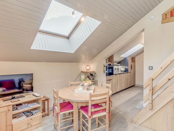 A compact living space with a dining area, kitchenette, and a TV. - Bright 3-room apartment for 6 people in the heart of Champagny-en-Vanoise (Champagny-en-Vanoise)