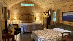 A cozy log cabin bedroom with two beds, a dresser, a desk, and a chair. - Hideaway from it all ! Holyfield Hideaway, Flag Pond, Tennessee  (Flag Pond)