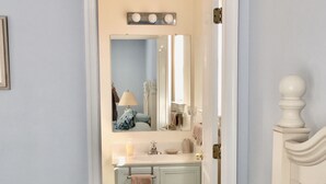 A bathroom with a sink, mirror, and towel rack. - Rehoboth Beach-Luxury Villa-Linens Included (Rehoboth Beach)