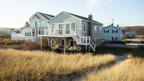A two-story house with a balcony and a covered porch.