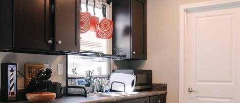 Microwave, dishwasher, coffee/tea maker, cookware/dishes/utensils