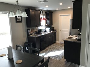 Microwave, dishwasher, coffee/tea maker, cookware/dishes/utensils