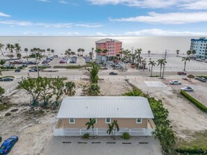 A beachfront hotel with a parking lot, beach view, and palm trees. - Beach, pool & fun times @ the Blue Lagoon! (Fort Myers Beach)