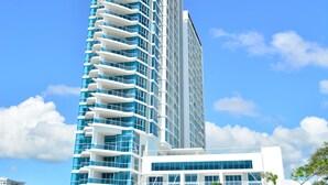 A tall, modern hotel with a curved facade and balconies. - OCEAN VIEW APARTMENT on the beach (Nueva Gorgona)