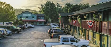 A parking lot with several cars parked in front of a building labeled "Pinnacle Inn."