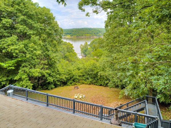 A view from a deck overlooking a lake, surrounded by dense trees. - Lake Front Beauty (Eucha)