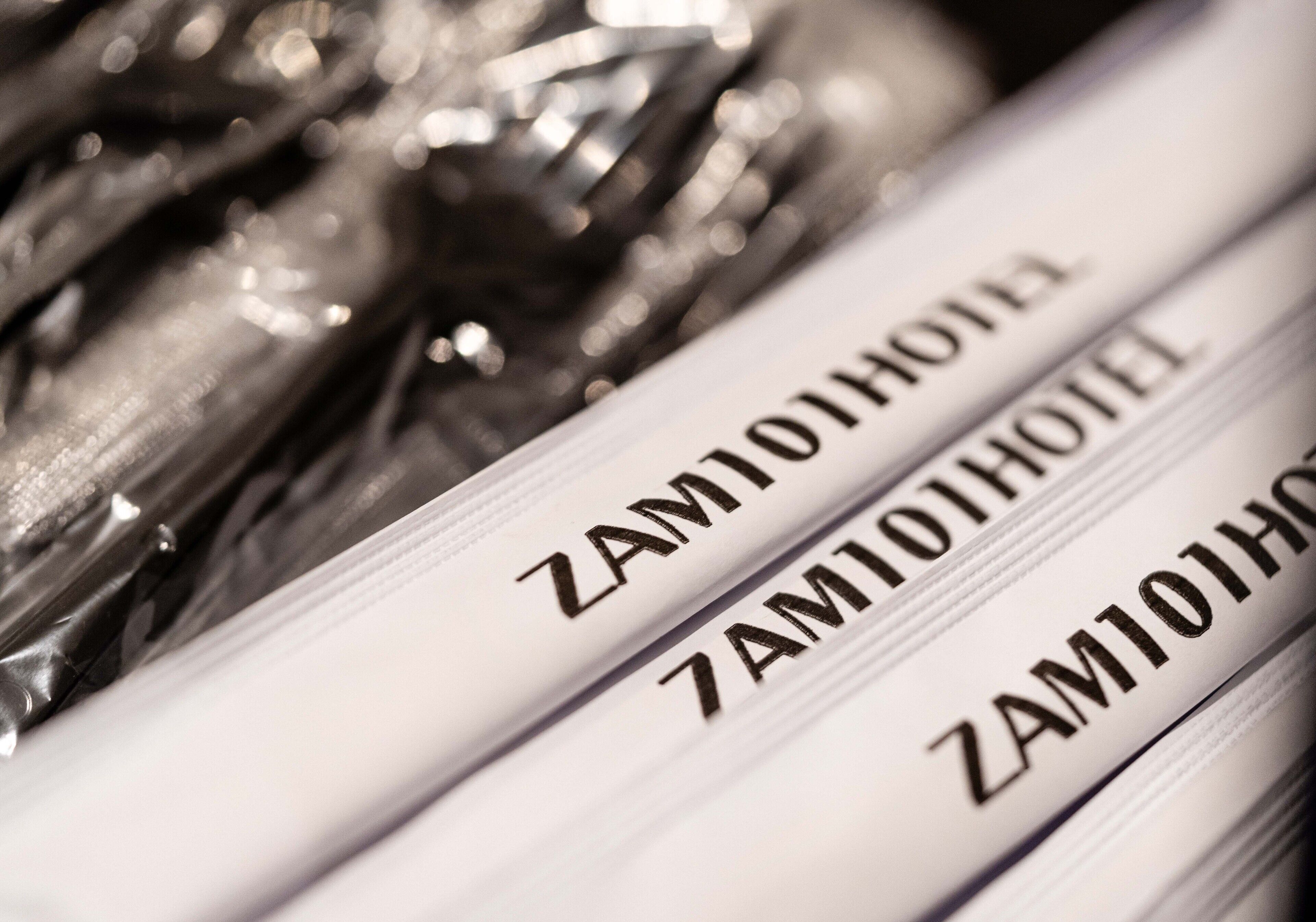 A close-up of hotel room keys with the name "ZAMIOHOI HOTEL" engraved on them.
