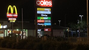 A night scene with illuminated signs for McDonald's, Coles, and other businesses. - BEACH, SHOPS & STRAND 5 min walk away (North Ward)