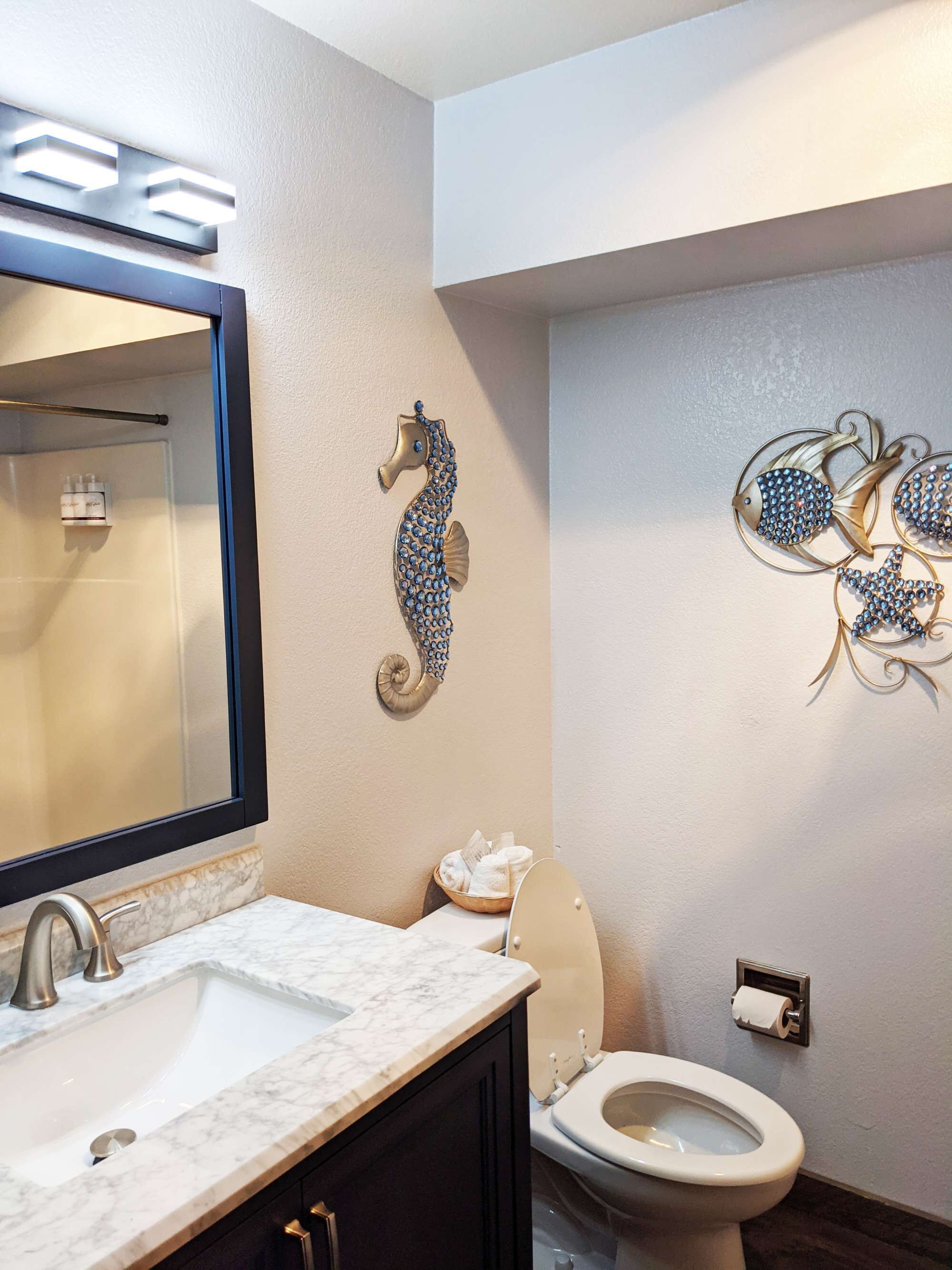 Een bad/douchecombinatie, een haardroger, handdoeken