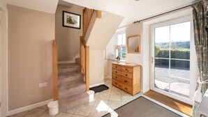 A staircase leading to a landing with a wooden dresser and a mirror. - Luxury Cottage in the Scenic Borders of Scotland (Canonbie)