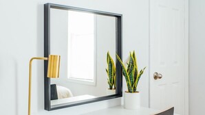 A white desk with a gold lamp, a large mirror, and two potted plants. - 2R- ❤️ Stylish and Cozy 2BR in Logan Square! (Chicago)