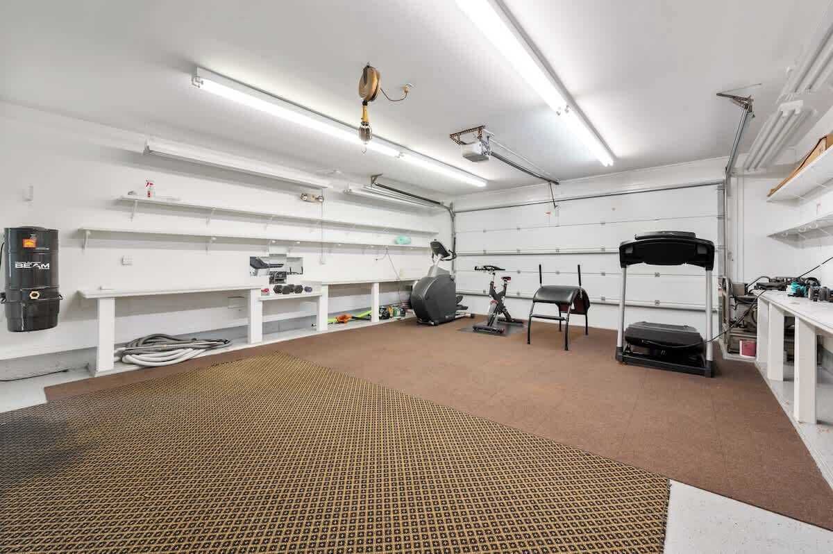 A gym with exercise equipment, a treadmill, and a stationary bike.