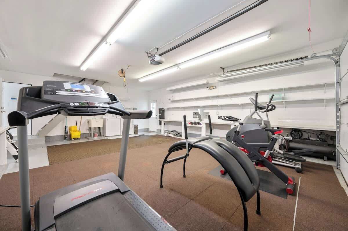 A gym with treadmills, stationary bikes, and a rowing machine.
