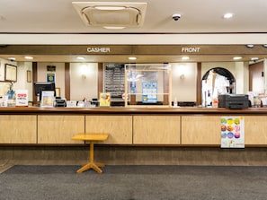 Check-in and enjoy a seamless experience at our hotel's reception area, featuring a cashier and front desk.