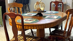 A dining area with a round wooden table, four chairs, and a decorative centerpiece. - Enjoy a cozy holiday getaway in our peaceful rural home.
WIFI NOT AVAILABLE (Mead)